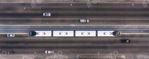 Preview: A top-down view of a multi-lane urban road with a central elevated rail track,