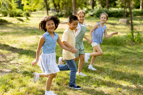 Preview: Group of asian and caucasian kids having fun in the park