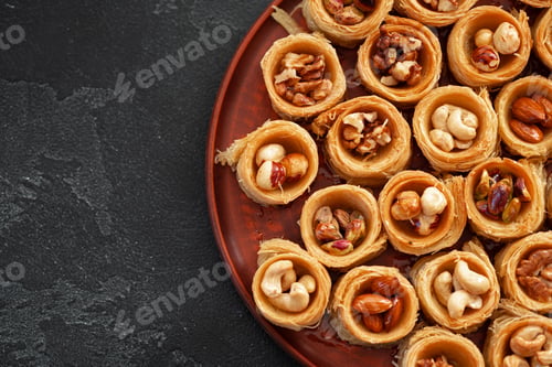 Preview: Delicious baklava dessert in oriental setting on black background
