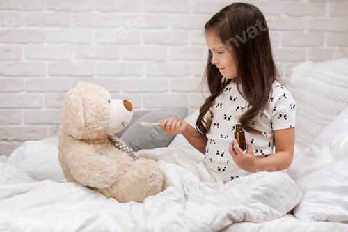 Preview: cute child girl playing doctor with teddy bear