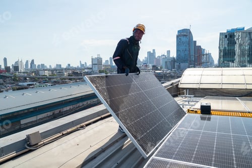 Preview: Engineers and technicians check drawings for installing solar cell panels on the roof.