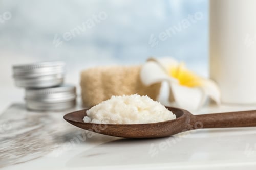 Preview: Spoon with Shea butter on marble table, closeup