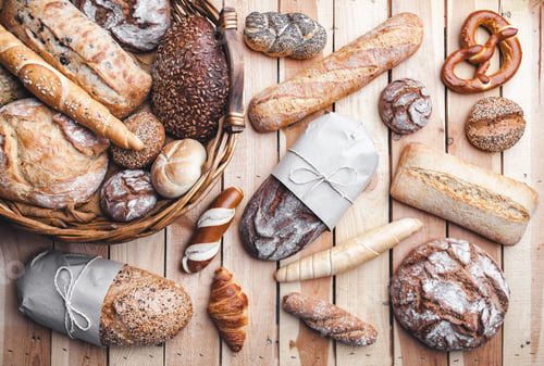 Preview: A basket full of delicious fresh bread on wooden background