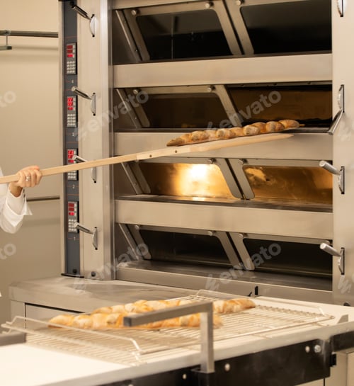 Preview: Baking bread in the oven in bakery.