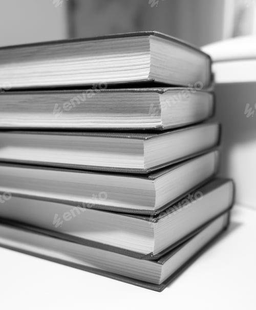 Preview: Stack of books on a white background. One book is yellow.