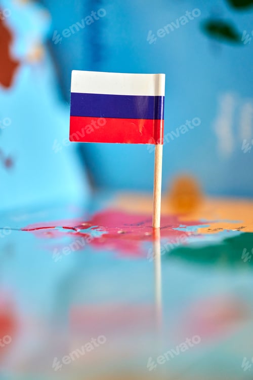 Preview: Closeup of a flag of Russia with a small stick on the map