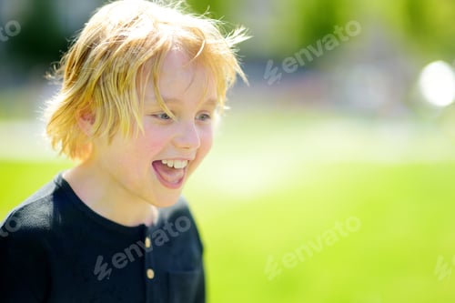 Preview: Portrait of happy preteen boy during walks on sunny summer day