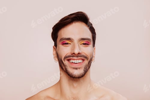 Preview: Beauty portrait of happy smiling gay man with eyeshadow