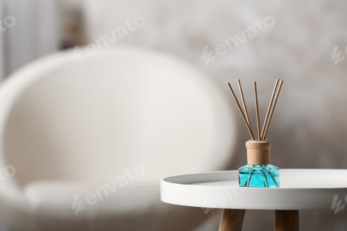 Preview: Reed air freshener on white table indoors, space for text