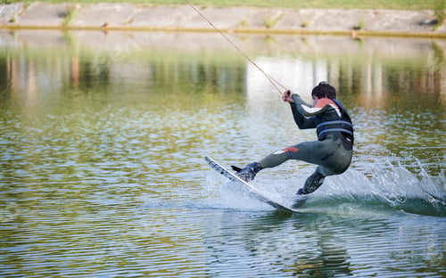 Preview: Young surfer having fun wakeboarding in the cable park.