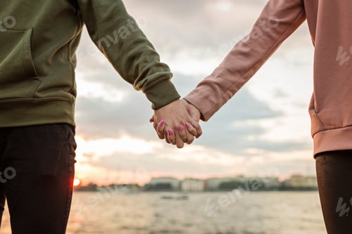 Preview: Young millennial or generation z couple in love in romantic relationships holding hands outdoor
