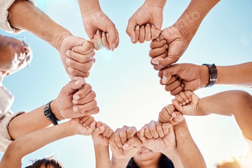 Preview: Hands, family and unity with a group of people in a huddle outdoor in nature during summer together
