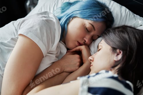 Preview: Close up of lesbian couple sleeping together in bed