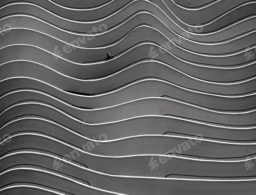Preview: Closeup greyscale shot of a building with curvy twists in Berlin, Germany