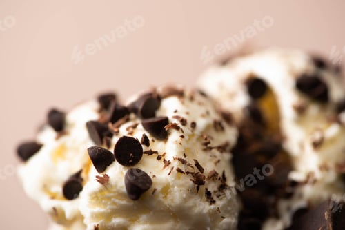 Preview: Selective focus of ice cream with chocolate chips on beige background
