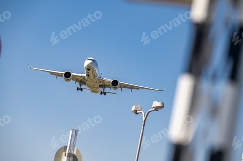 Preview: Low angle shot of an airplane flying closer at daytime
