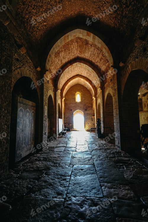 Preview: Vertical shot of a arches type hallway with the door in the distance