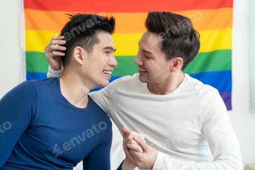 Preview: Portrait of Asian handsome man gay family holding LGBT flag and smile.