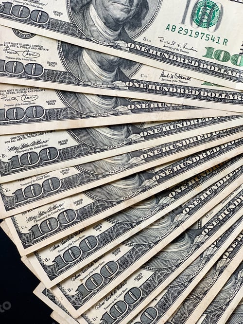 Preview: Stack of One Hundred Dollar Bills on Black Surface