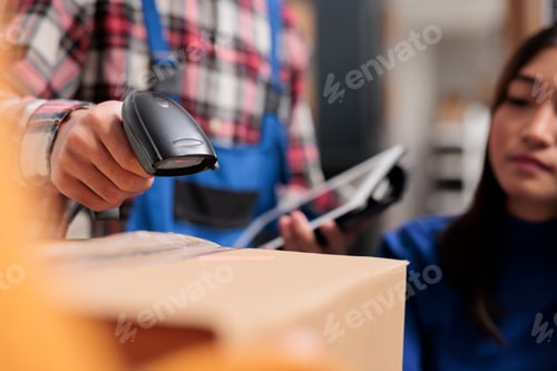 Preview: Freight distribution center employee using barcode scanner in warehouse