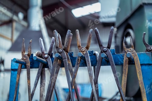 Preview: Row of tongs in industrial forge