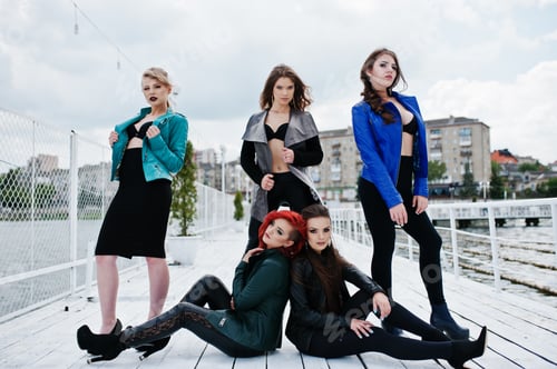 Preview: Group of sexy models girls in black bra and leather jackets on the dock