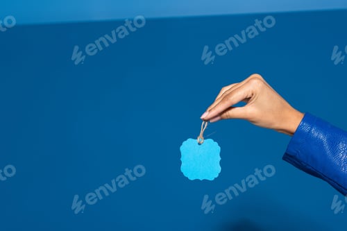 Preview: cropped view of african american woman holding blank label on blue background