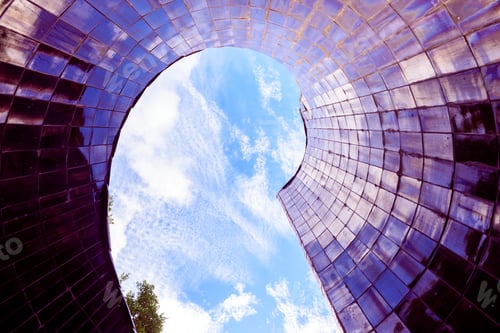 Preview: Conical smooth tile surface pointing to the blue sky with reflections of an abstract background.