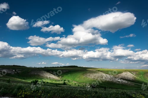 Preview: Beautiful clouds on the blue sky and summer green field landscape