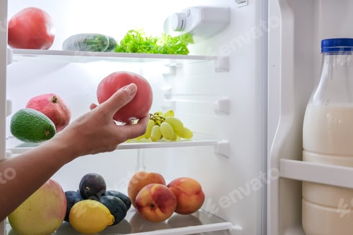 Preview: open fridge with fresh fruits and vegetables. refrigerator with healthy food.Healthy food concept