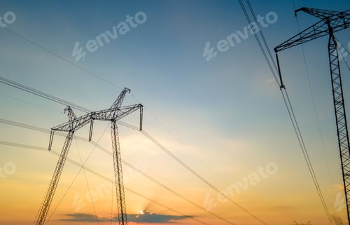 Preview: High voltage towers with electric power lines at sunset.