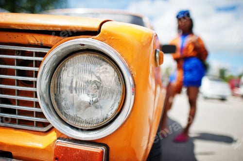 Preview: African american lady near orange classic retro car