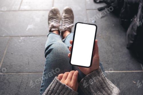 Preview: a woman holding black mobile phone with blank desktop screen with baggage