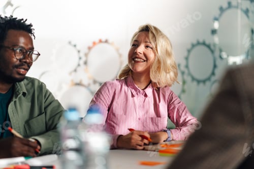 Preview: Creative people working together on a project in modern office