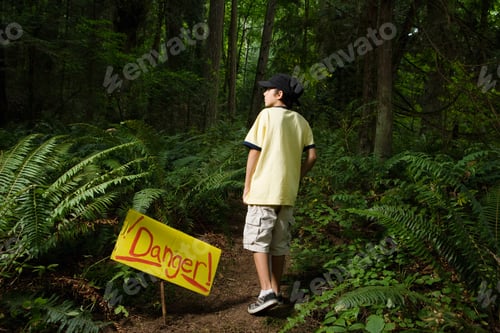 Preview: Boy by danger sign