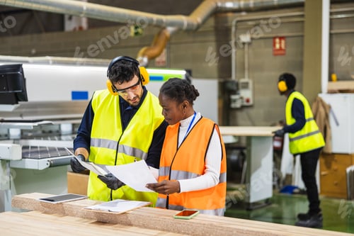 Preview: Lumberyard workers reviewing production documents together