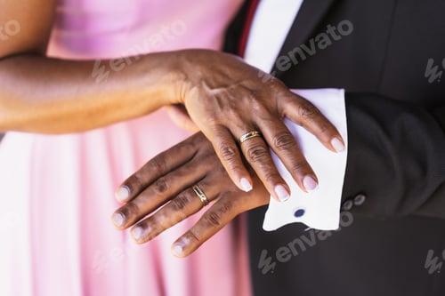 Preview: Black ethnic wedding couple showing rings at a wedding, marriage ceremony