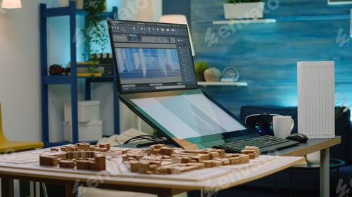 Preview: Woman working as architect looking at maquette on computer