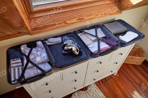 Preview: Open luggages on wooden cabinet