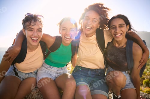 Preview: Portrait Of Female Friends With Backpacks On Vacation Taking A Break On Hike Through Countryside
