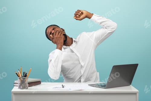 Preview: African american businessman yawning and stretching hands, looking sleepy, sitting at workplace