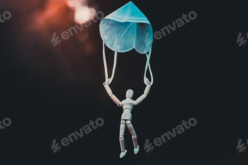 Preview: Wooden figure flying with mask as parachute, destined to prevent the spread of the coronavirus,