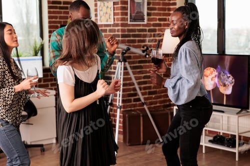 Preview: Smiling african american woman dancing with friends