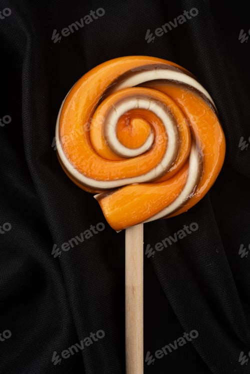 Preview: orange and black lollipop on a stick