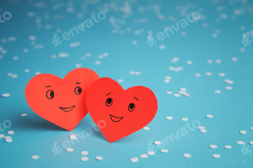 Preview: Two red smiling hearts on a blue background. St. Valentine's Day. Couple in love.