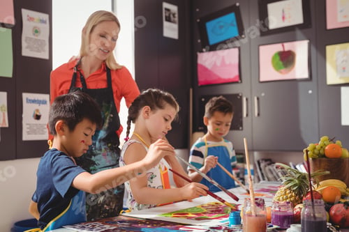 Preview: Teacher assisting schoolkids in drawing class