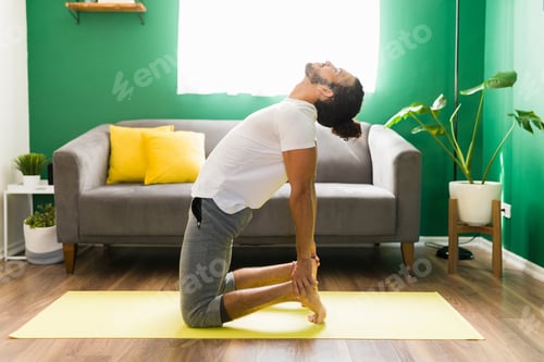 Preview: Side view of a young man stretching his back
