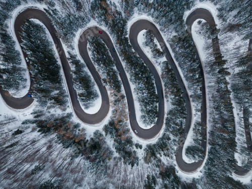 Preview: Aerial top down view of winter winding road in the forest, Transylvania, Romania.