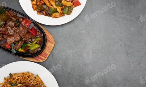 Preview: Variety of oriental dishes on a rustic background with space for text