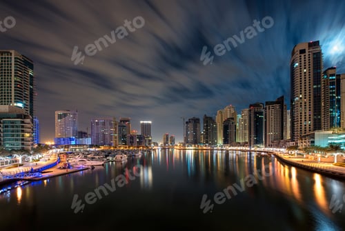 Preview: Cityscape of Dubai, United Arab Emirates at dusk, with skyscrapers and the marina in the foreground.